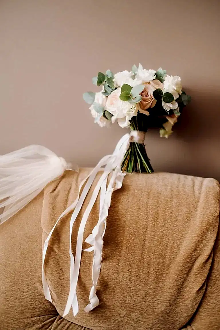 wedding bouquet with roses on a chair and boutonni 2MFPZ5K